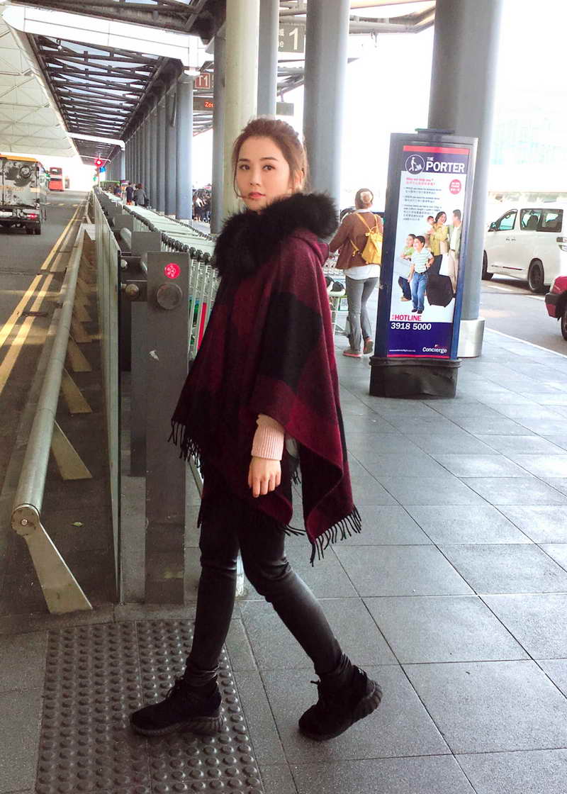 Charlene Choi wearing Burberry poncho at Hong Kong Interntation Airport on 29th November 2016