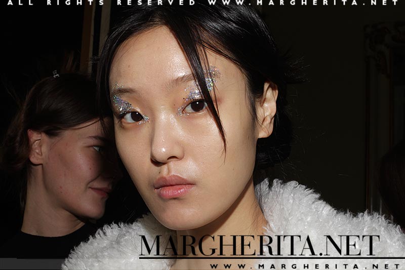 Make-up at Genny FW 2018 2019. Glitter eyes and a beautiful skin. Make-up: Lloyd Simmonds